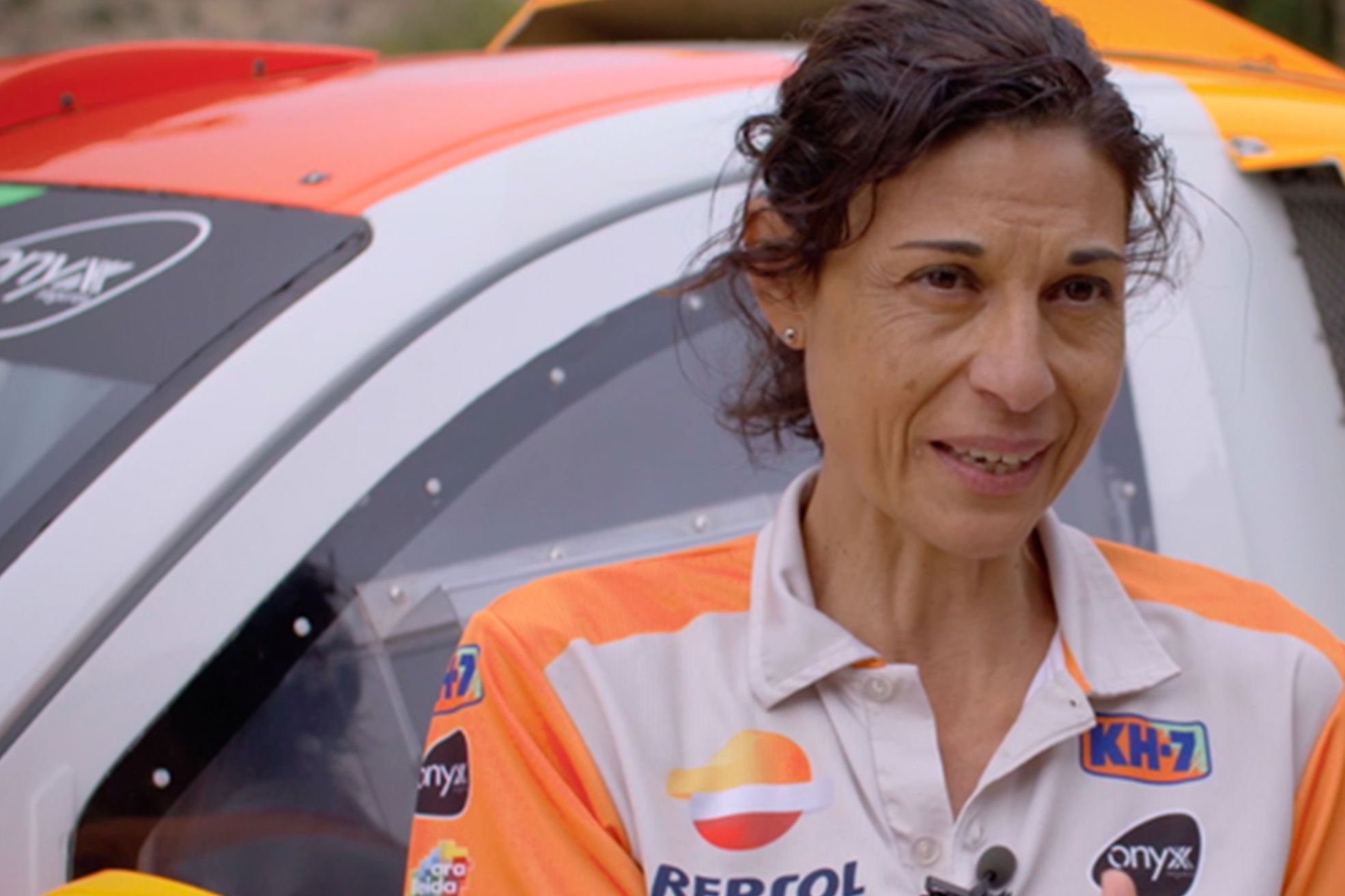 Lidia guerrero in front of a rally car